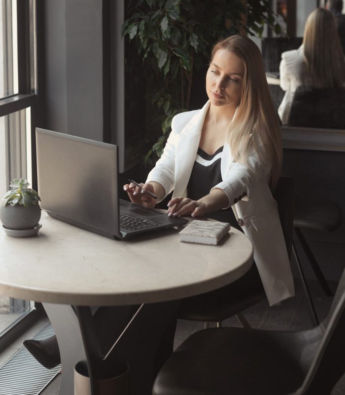 business-woman-working-with-laptop-in-cafe-with-black-interior.jpg